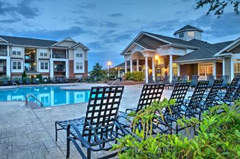 Refreshing pool with spacious sundeck and a city view at Abberly Woods Apartment Homes by HHHunt, North Carolina, 28216